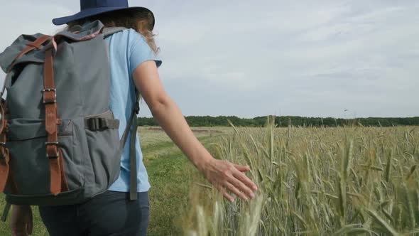 Woman Travels With a Backpack in Beautiful Places