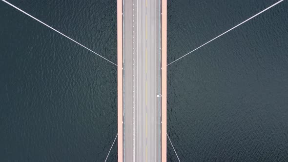 Mighty Cables holding suspension bridge Hardangerbrua - Forwarding birseye aerial over bridge with c