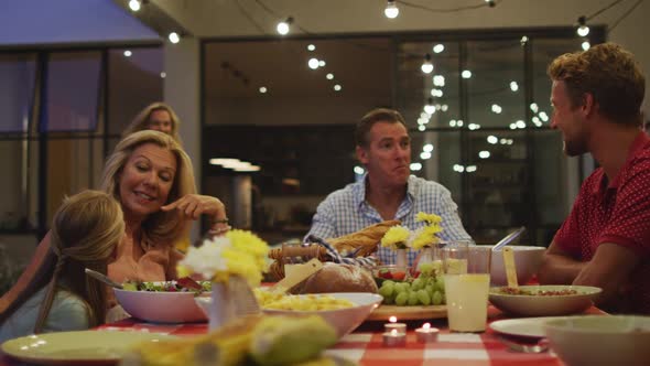 Happy family eating dinner together.