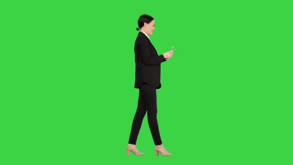 Happy Business Woman Counting Money While Walking on a Green Screen Chroma Key