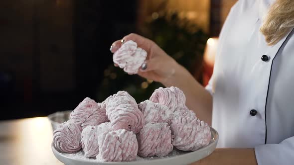 Female Baker Hands Taking Marshmallow from the Plate