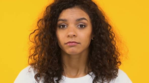 Mixed-Race Girl Shrugging Shoulders, Unsure of Decision, Uncertain Emotions