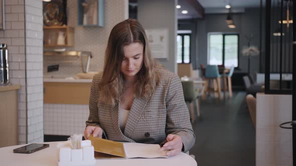 Young Business Woman Having Breakfast in the Hotel Restaurant