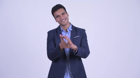 Happy Young Indian Businessman Clapping Hands