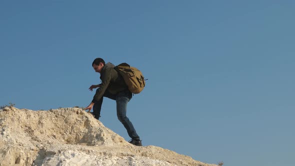 Tourists Give Hand To Each Other, Climbing To Top of Hill. Teamwork of Business People. Team of Male