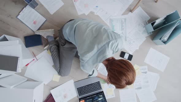 Timelapse of Freelance Business Journalist Sitting on Floor, Working on Article