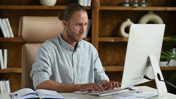 Happy Excited Lucky Caucasian Young Man Stylishly Dressed Office Worker Freelancer Ceo Sits at Work