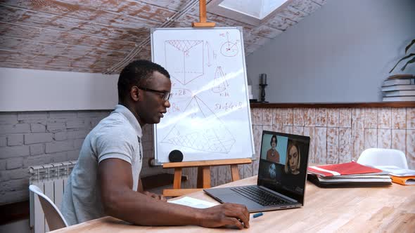 An Online Maths Lesson - an African-american Man Teacher Doing a Test with His Students on the