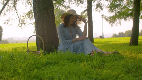 Poetic Beautiful Girl Sitting in A Park