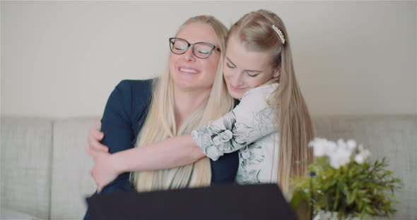 Two Happy Sisters Hugging Together and Giving Support To Each Other Smiling Into Camera