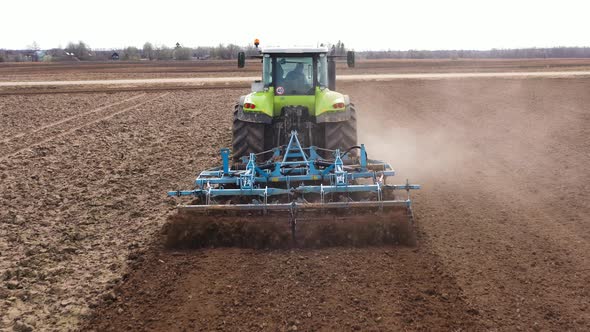 The Tractor Plows the Field Prepares for Crops