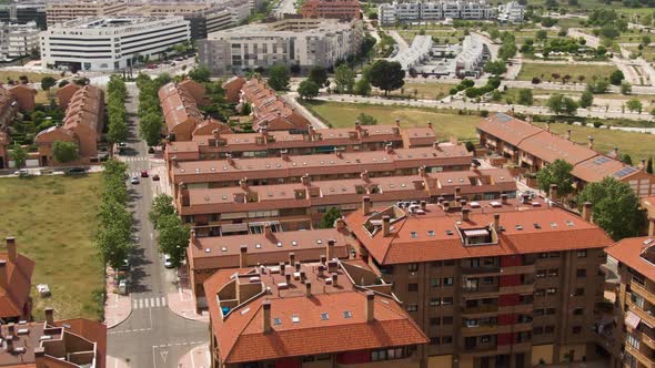 Spanish living district of apartment building on hot day, aerial fly over view