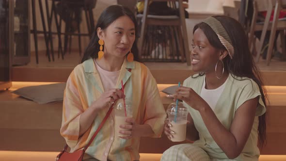 Female Best Friends Having Conversation in Cafe