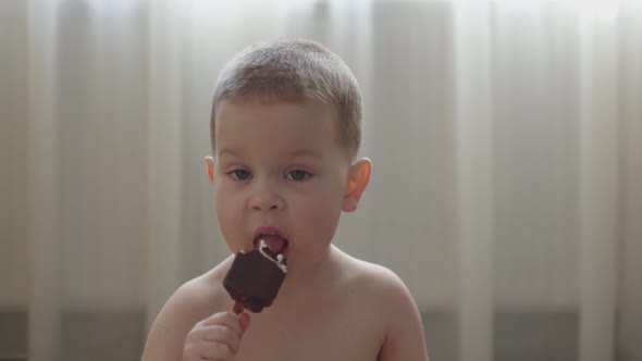 Naked Caucasian Baby Boy Eating Licking Icecream in Livingroom Hot Sunny Day