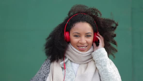Young African American Woman is Listening Music and Having Fun Outdoors Spbi