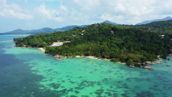 Wide angle flying island view of a white sandy paradise beach and blue ocean background in colorful 