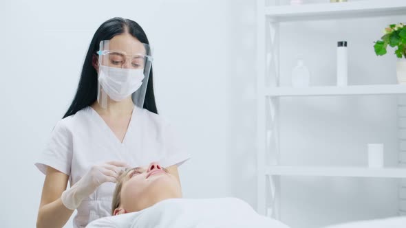 Beautician Doing Injection in Hair for Young Woman