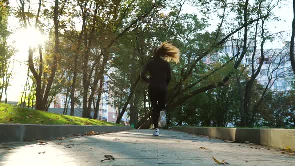 Female Jogger Training in Sunny Park