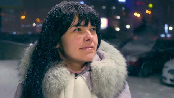 Happy Beautiful Girl Walking Down Street During Blizzard Snowfall. Young Adult