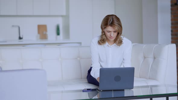 Female Using Computer in Flat