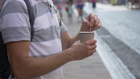 Man stirring in his coffee cup