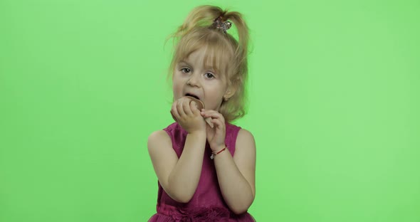 Girl in Purple Dress with Chocolate Egg. Happy Four Years Old Child. Chroma Key