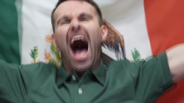 Mexican Fan Celebrates Holding the Flag of Mexico