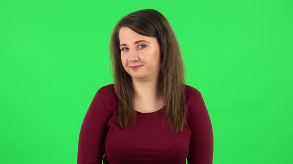 Portrait of Pretty Girl Is Smiling and Shrugging. Green Screen