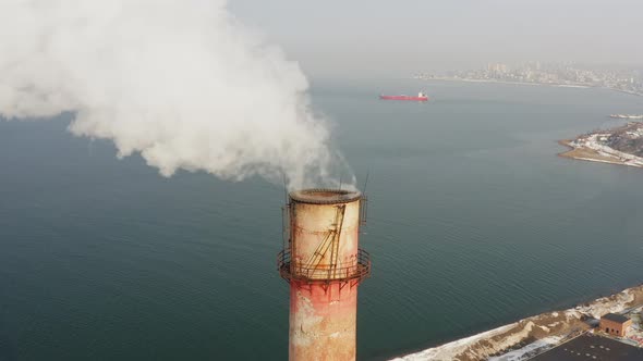 Aerial Video on the Chimney of an Power Plant From Which White Smoke Comes Out