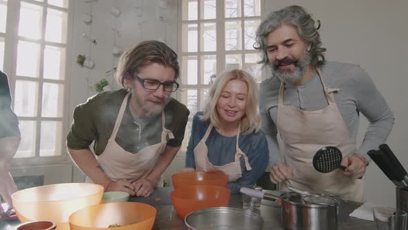 Small Group Of People Cooking Together