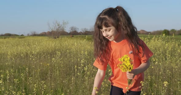 The child collects flowers in the spring.