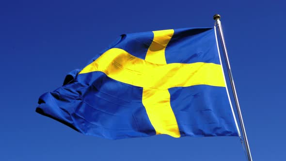 The Swedish flag caught majestically waving on a clear summer day in the Mariefred region. The foota