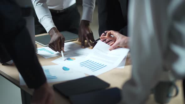 Business Meeting International Management Team at Work Team Is Standing Next To a Work Table and