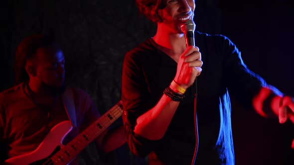 Male singer singing into a microphone 