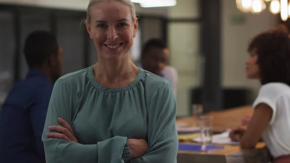 Portrait of caucasian businesswoman in a meeting room looking to camera smiling