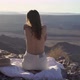 Young Woman Sitting Topless on Blanket at Edge of Fish River Canyon in Namibia - VideoHive Item for Sale