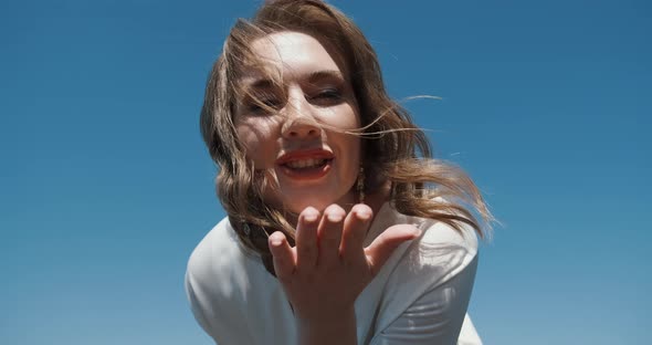 Portrait of Happy Young Woman with Sky on Background She is Carefree