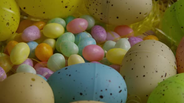 Rotating Shot of Easter Decorations and Candy in Colorful Easter Grass