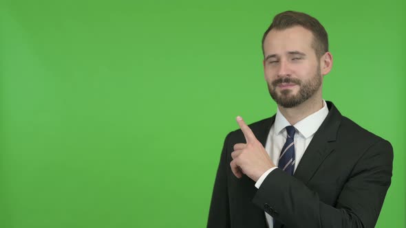 Young Businessman Pointing with Finger Without Against Chroma Key