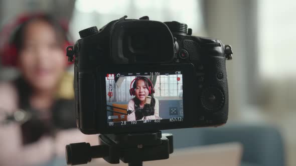 Camera Display With Asian Girl Sing A Song While Streaming. The Child Is Broadcasting