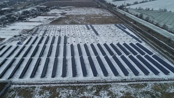 Lots of Snow Around the Solar Panels and the Mounting Racks Construction