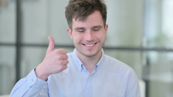 Portrait of Young Man Showing Thumbs Up Sign