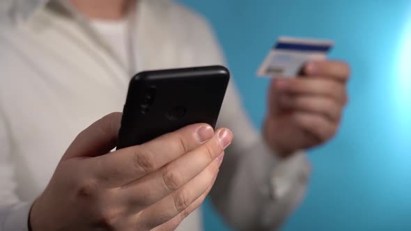 Man Enters Credit Card Information Into Smartphone