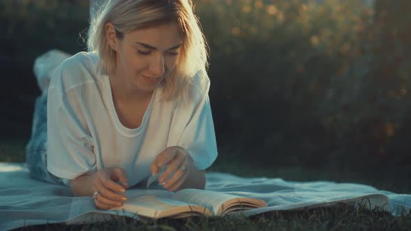 Attractive girl is reading a book