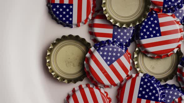 Rotating shot of bottle caps with the American flag printed on them - BOTTLE CAPS