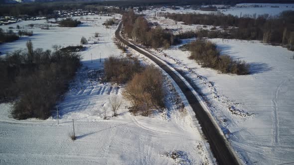 Aerial View of Car Moving on Road in Winter Season