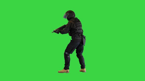 Police Unit in Black Tactical Suit Searching for a Target on a Green Screen Chroma Key