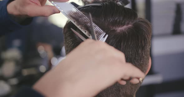 A Close Up of a Person Using a Hair Brush