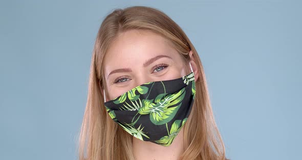 Studio Portrait of Young Woman Wearing a Face Flower Patterned Mask, Looking at Camera, Close Up