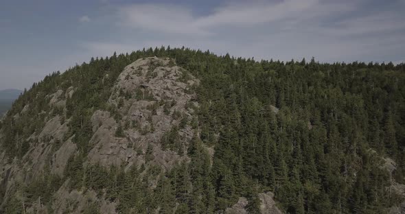 Aerial Drone Shot Orbiting Rocky Cliff Face Of Mountain